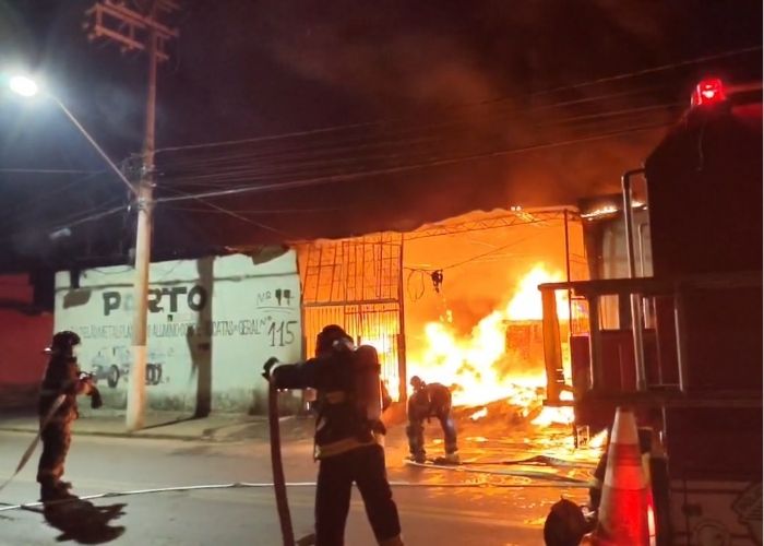 Imagem de um local pegando fogo e o Corpo de Bombeiros agindo
