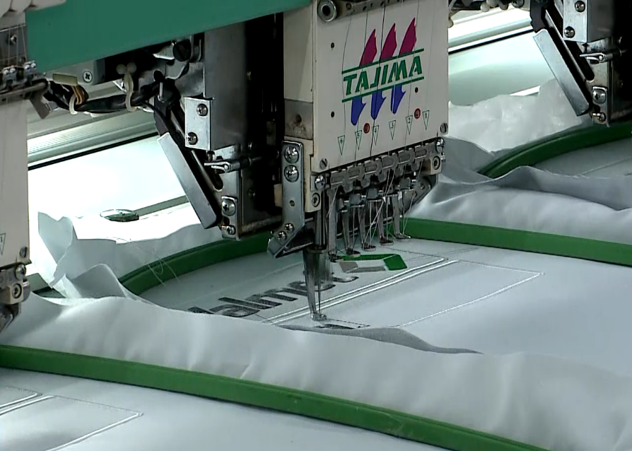 M&aacute;quina de costura produzindo roupa.